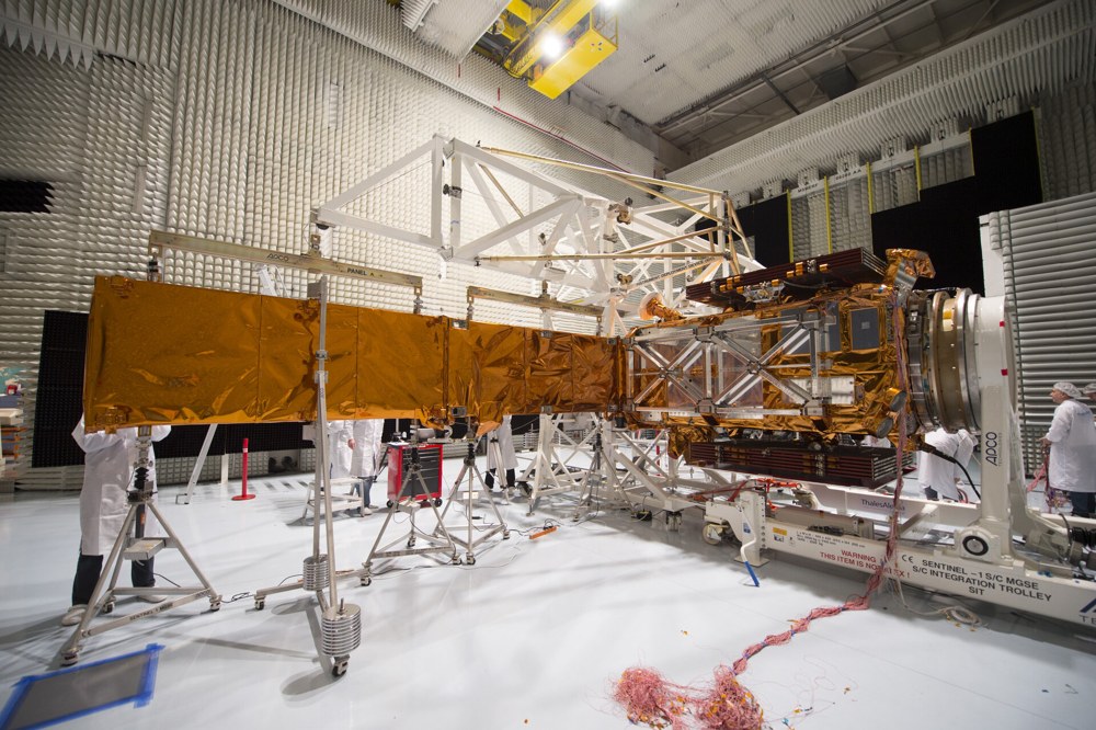 Sentinel-1A with its long radar antenna deployed in a cleanroom.